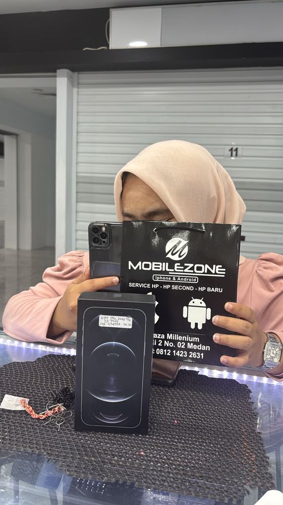 Pelanggan MobileZone Store dengan paper bag